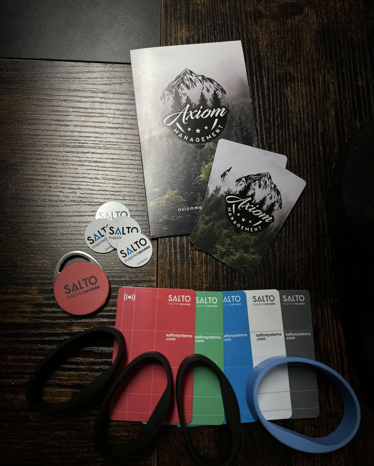 SALTO key cards, fobs and silicone wristbands alongside access cards custom-printed with a property management company's own branding