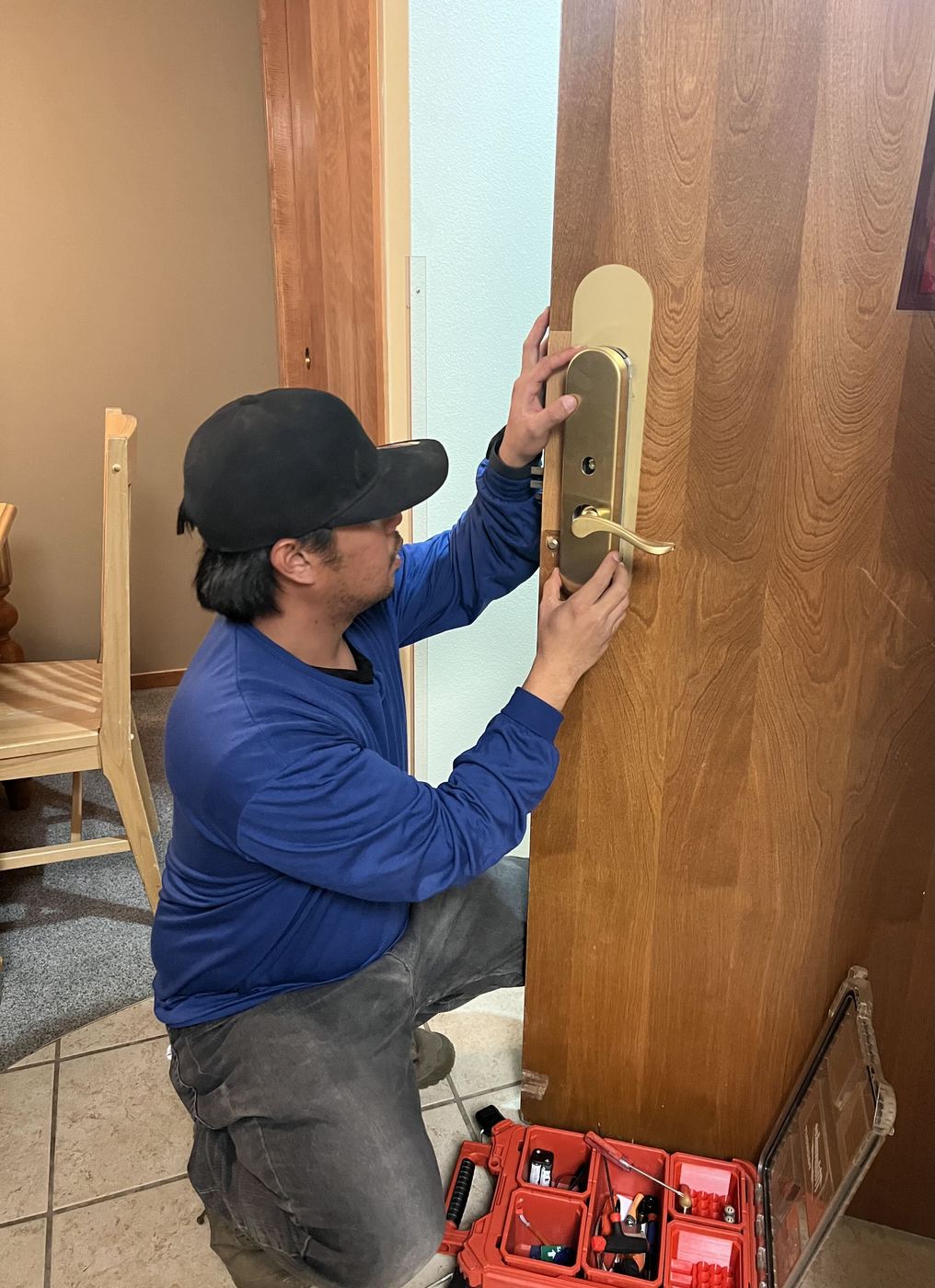Alpine Access Management technician fitting a SALTO XS4 escutcheon and lever onto a unit door